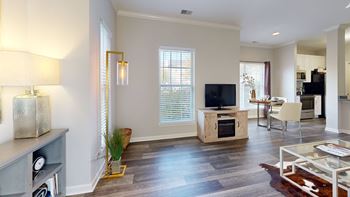 A living room with a tv and a dining room